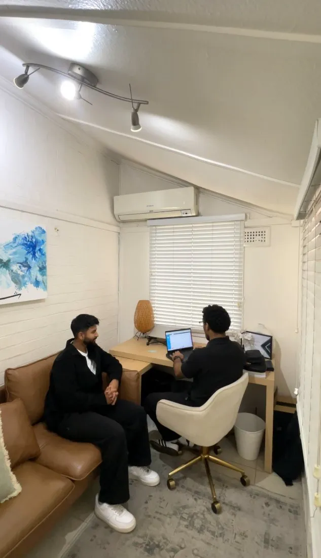 Imaad Karim taking a case history with a client in the consultation room