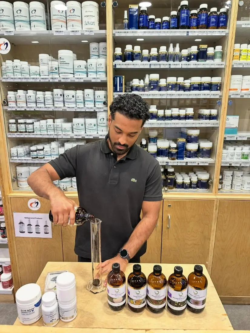 Imaad Karim measuring a herbal glycetract in the dispensary